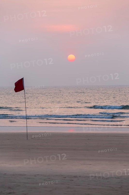 Lifeguard flag in sunset at Agonda Beach