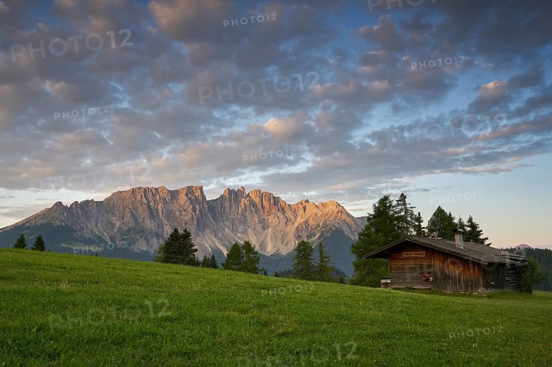 Latemar mountain range with alpine huts