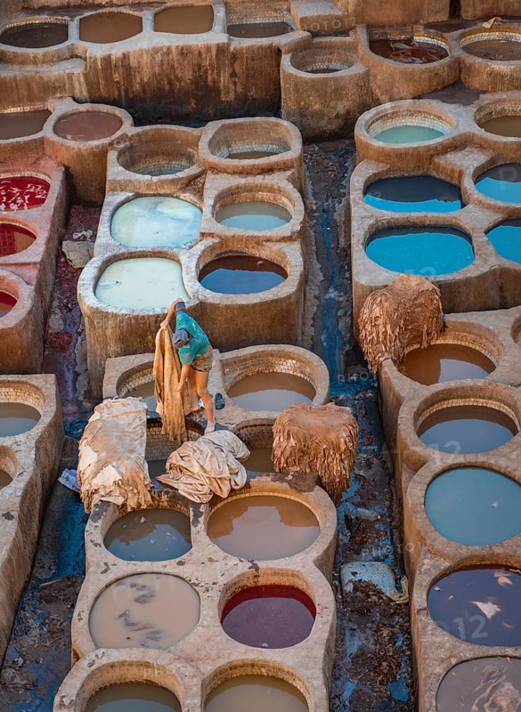 Worker dyeing leather