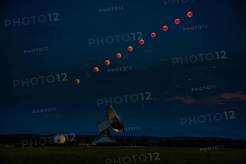 Satellite dish with blood moon and Mars as time lapse