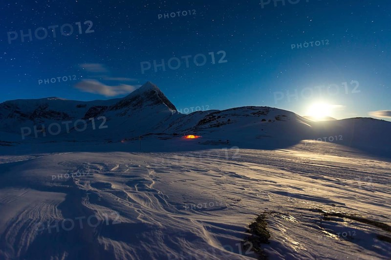 Full moon with tent in the snow