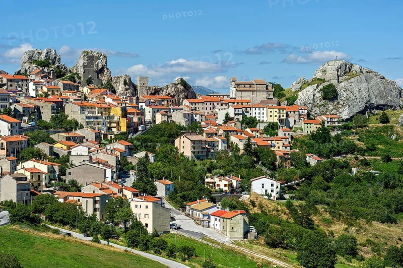 View of mountain village Pietrabbondante with medieval tower and church Chiesa di Santa Maria Assunta on rock Morg Caraceni
