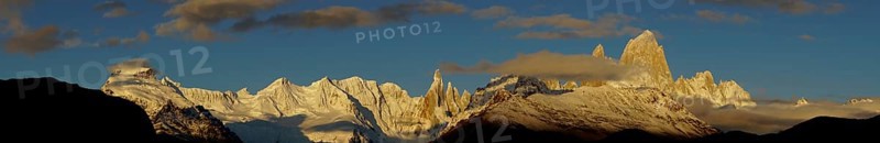 Snow-covered mountain range with Cerro Torre and Fitz Roy at sunrise