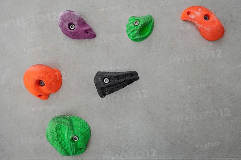 Coloured via ferrules or climbing grips on grey wall