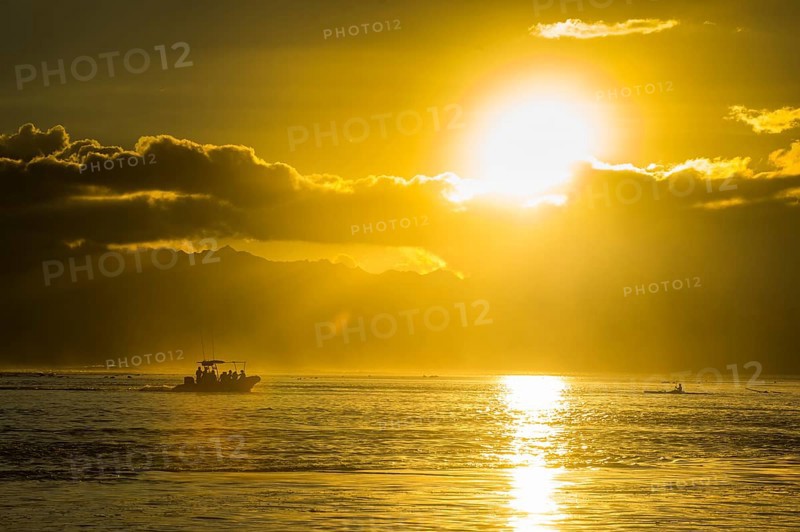Sihouette of a little boat at sunset