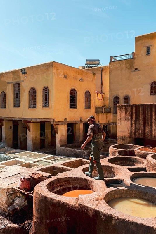 Worker dyeing leather