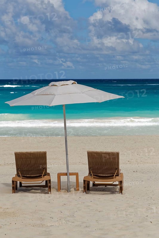 Two beach chairs with parasol on the beach