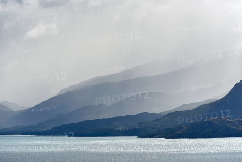 Clouds overhanging mountains at Lake Lago General Carrera (or also Lago Buenos Aires in Argentina)