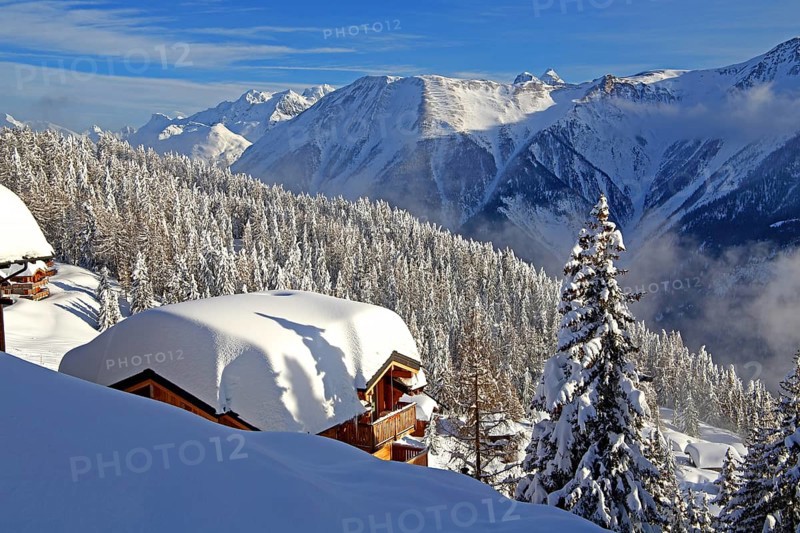 Winter landscape with snow-covered chalet