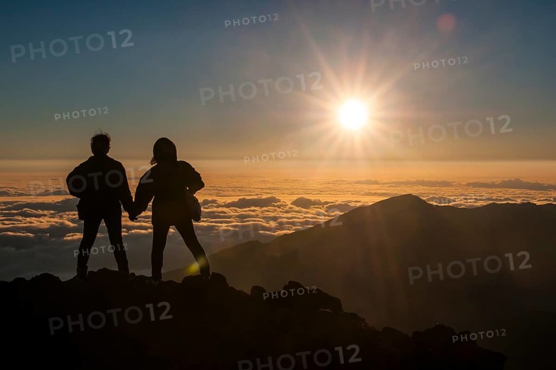 Tourists in backlight waiting for sunset on top of Haleakala National Park