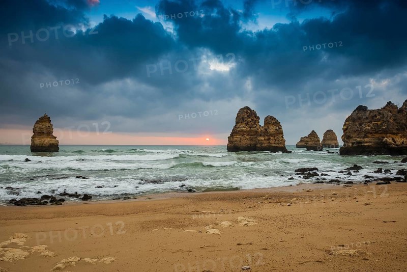 Rocky coast with beach and red rocks