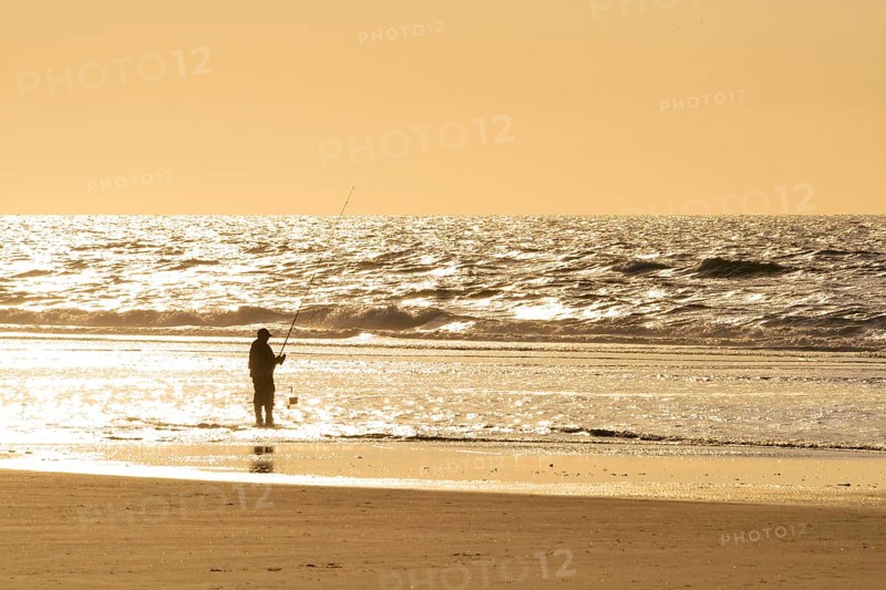 Fisher on the beach of the North Sea