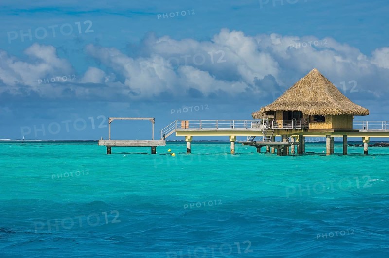 Overwater bungalows on stilts in luxury hotel