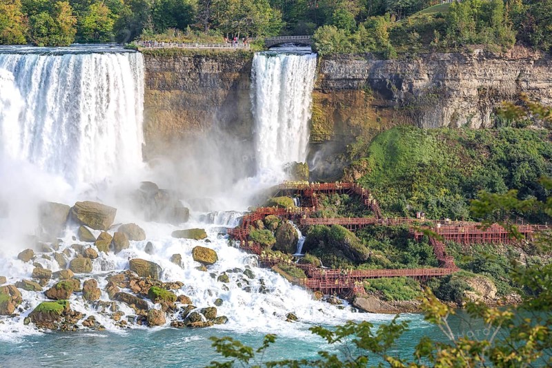 Tourists in front of waterfall