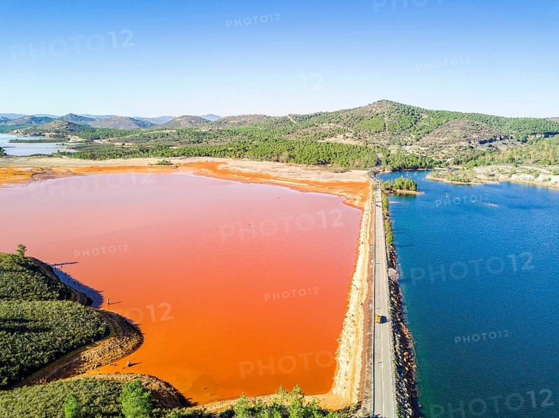 Street trough orange and blue lakes in mining region