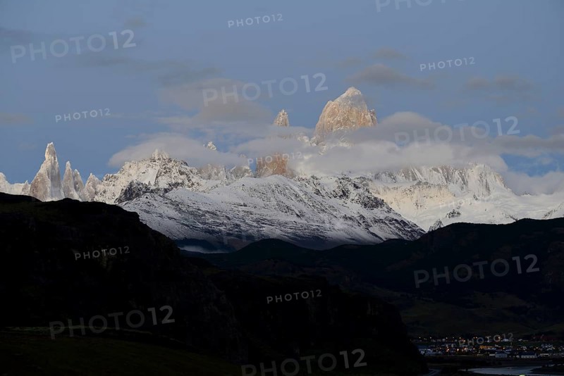 Snow-covered mountain range of the Fitz Roy and Cerro Torre with clouds at dawn