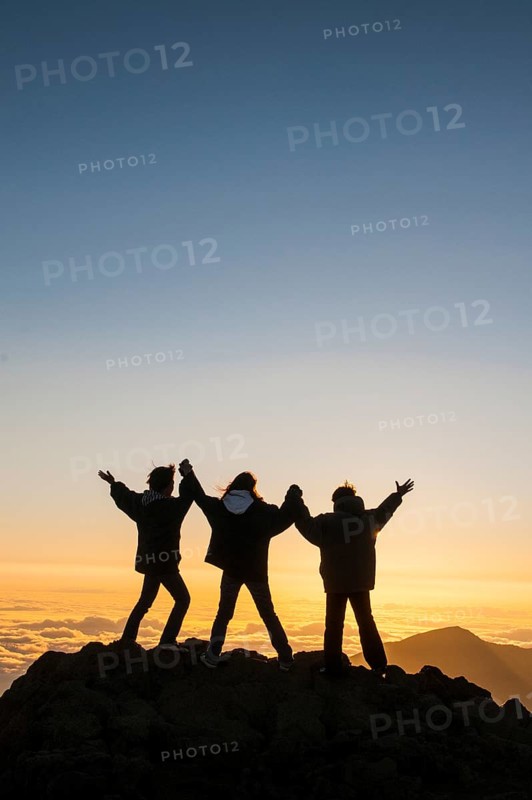 Tourists in backlight waiting for sunset on top of Haleakala National Park
