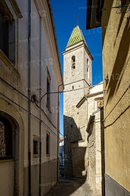 Narrow alleyway with bell tower of the church of San Nicola