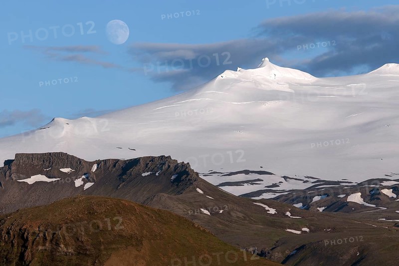 Snow-covered Snaefell volcano with Snaefellsjokul glacier and full moon