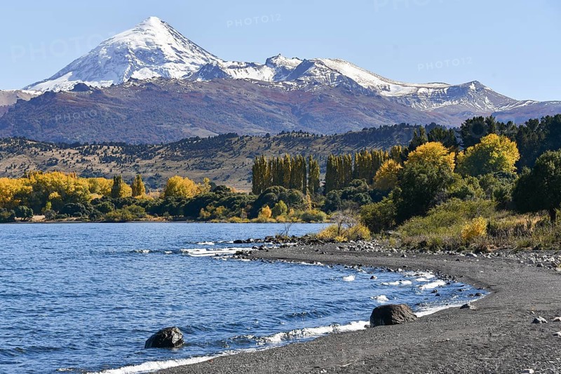 Lake Lago Lolog in autumn with the snow-covered volcano Lanin