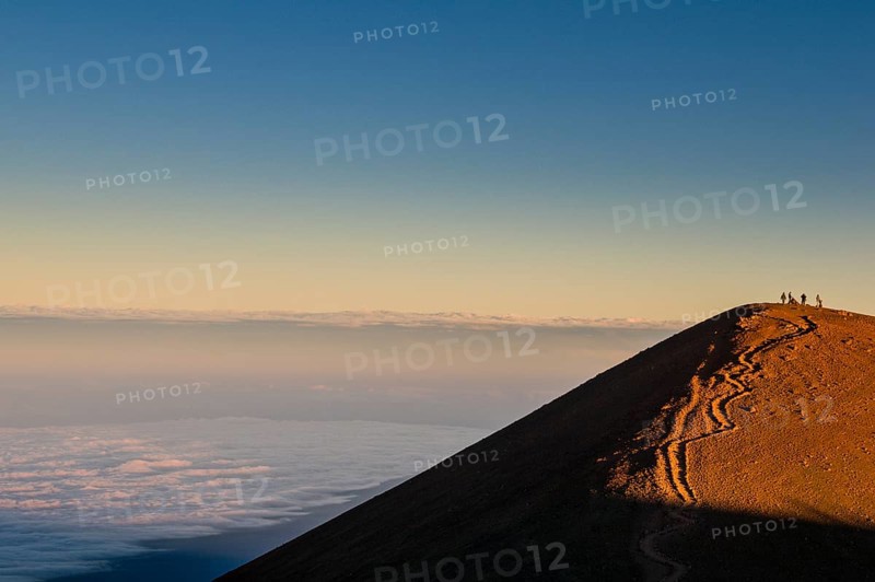 Tourists on a volcanic cone on top of Mauna Kea