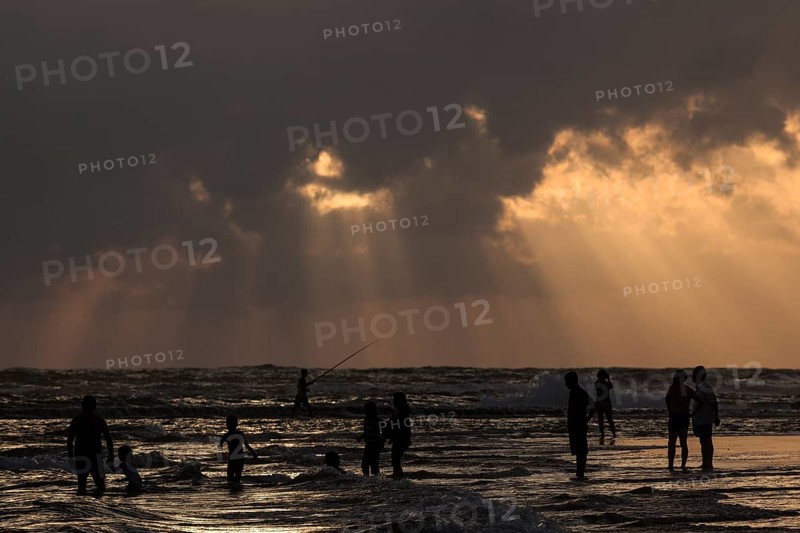 People in backlight on beach