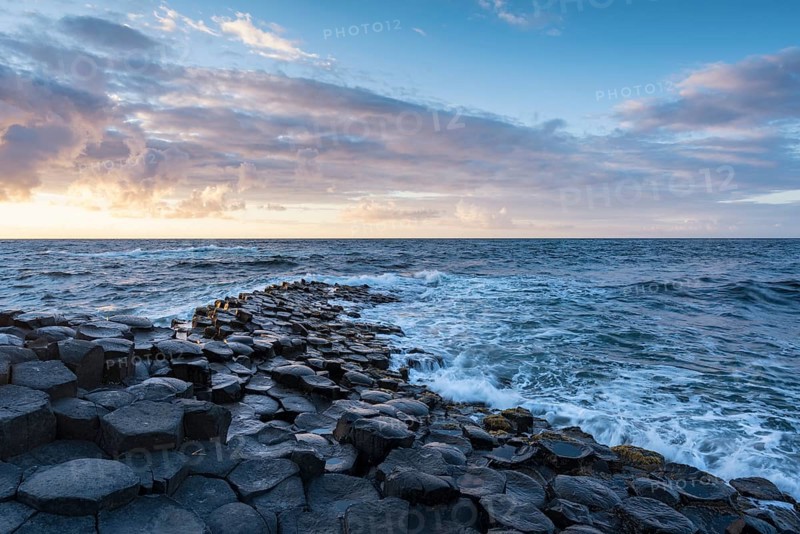 Basalt columns by the coast at sunset