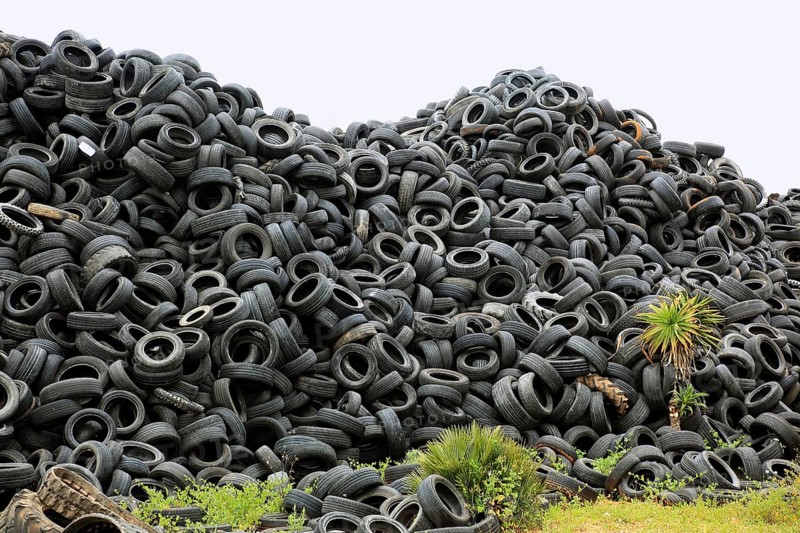 Old car tires lying on a pile for recycling