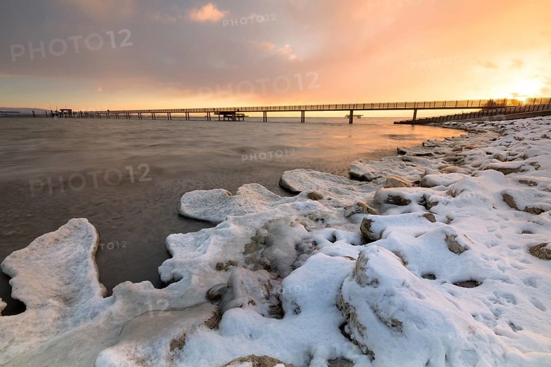 Sunrise with ice and snow on the shore of Lake Constance