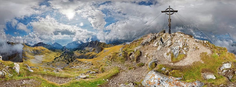 360 mountain panorama from Hochiss summit with summit cross and bizarre cloudy sky
