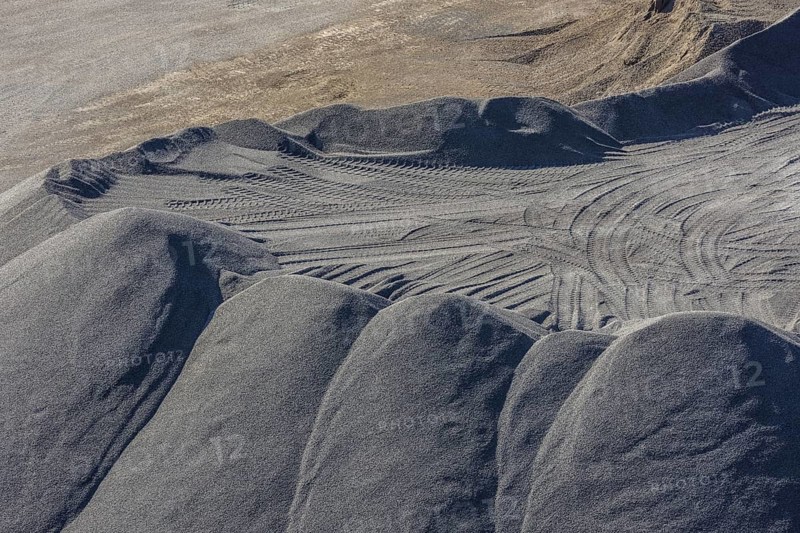 Sand heaps and excavator tracks in the basalt quarry