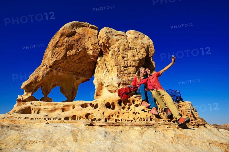 Hikers climb Elephant Rock outside of Petra