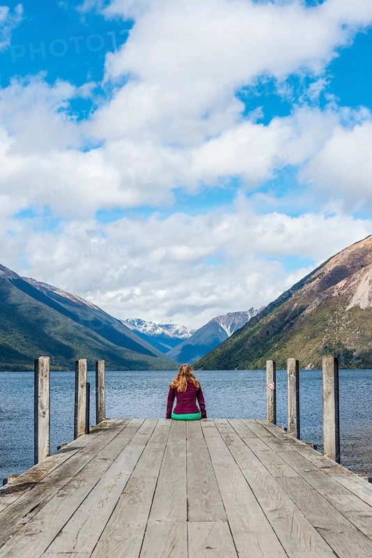 Woman sitting on dock