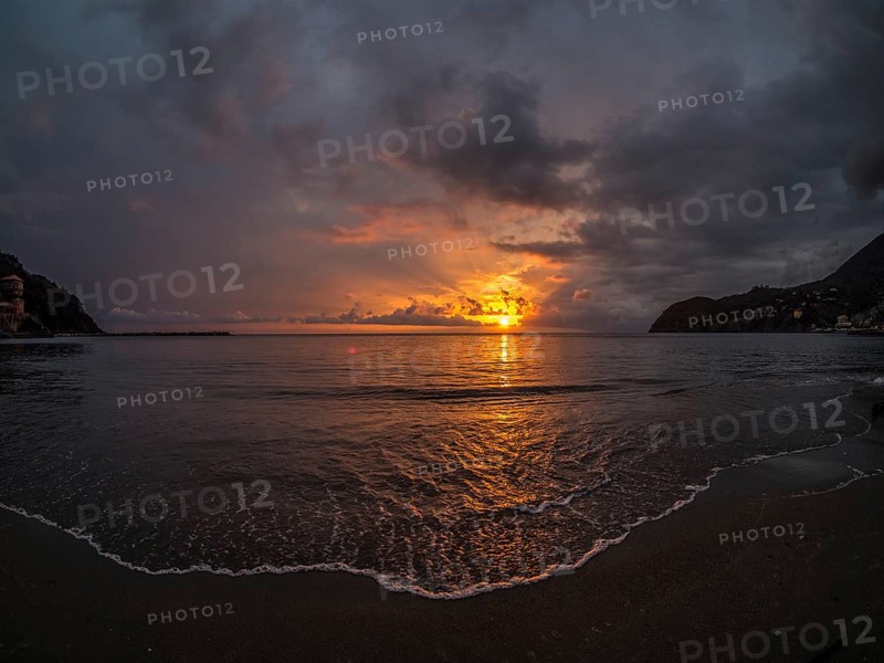 Sunset behind clouds over the sea
