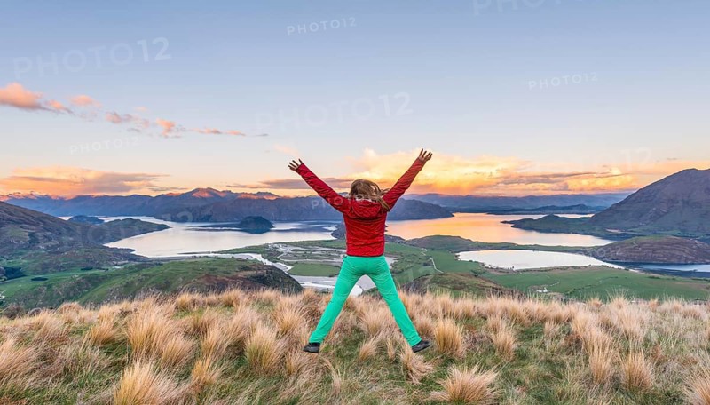 Hiker jumping with limbs spread out in the air