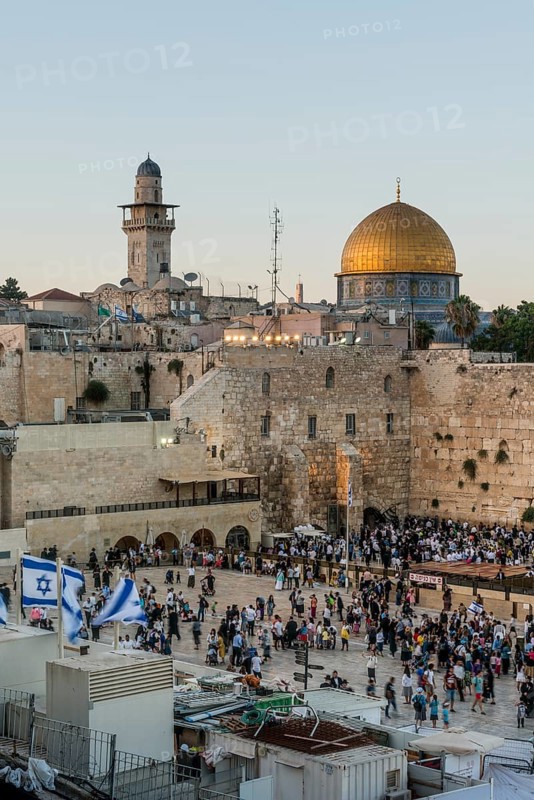 Believers at the Wailing Wall at dusk
