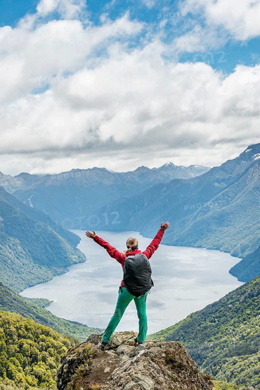Female hiker is looking at the South Fiord of Lake Te Anau