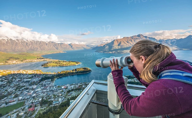 Woman looking through telescope