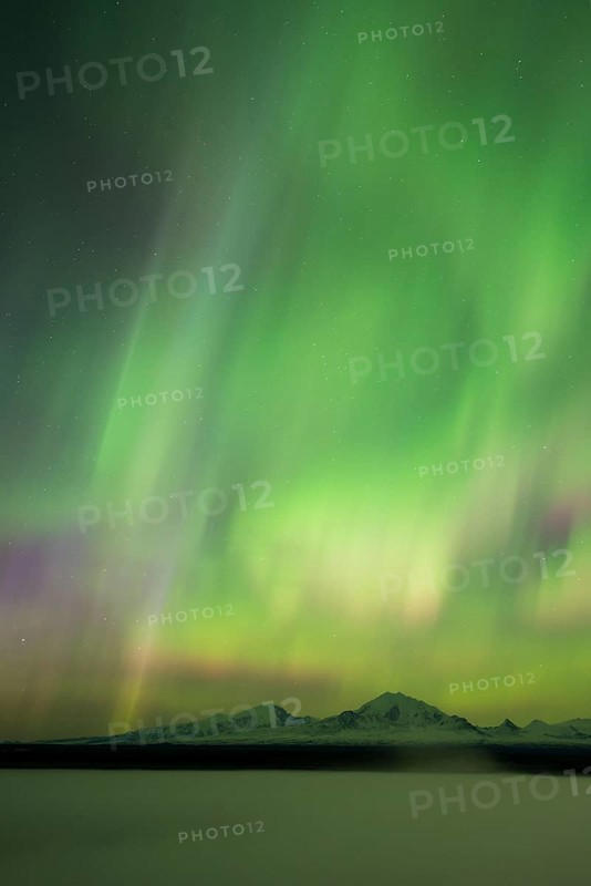 Aurora over the fog shrouded Copper River and mounts Sanford Drum and Wrangell
