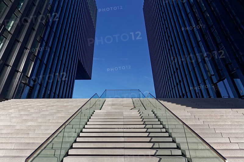Wide staircase leading upwards between skyscrapers