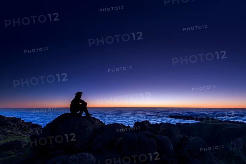 Sunrise with person on mountain peak