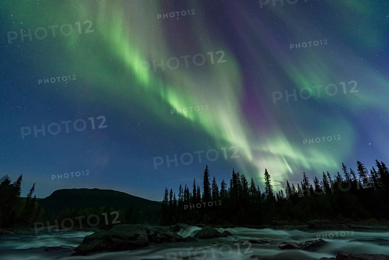 Northern Lights or Aurora Borealis above river Gamajahka or Kamajakka