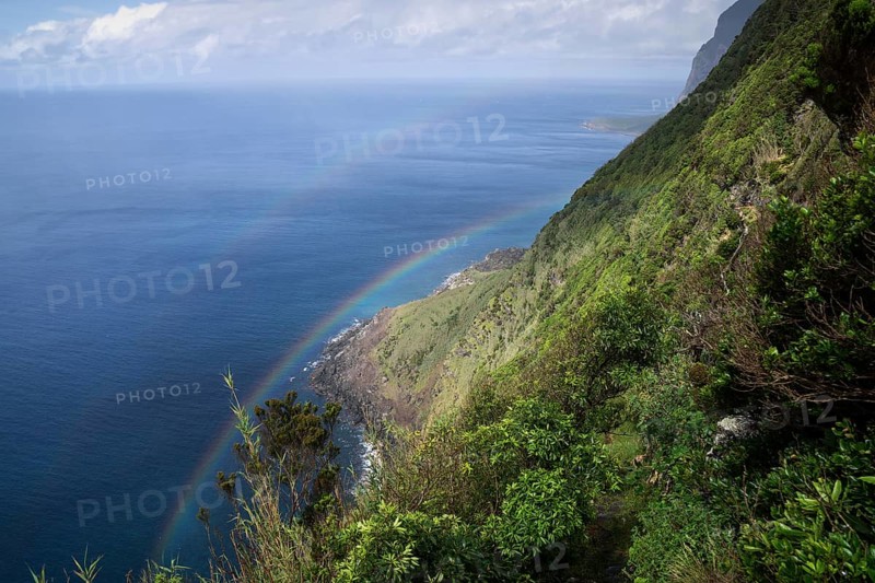 Steep coast with rainbow at Faja de Lopo Vaz