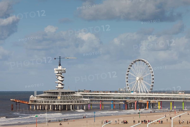 Pier with bungee jumping tower and Ferris wheel