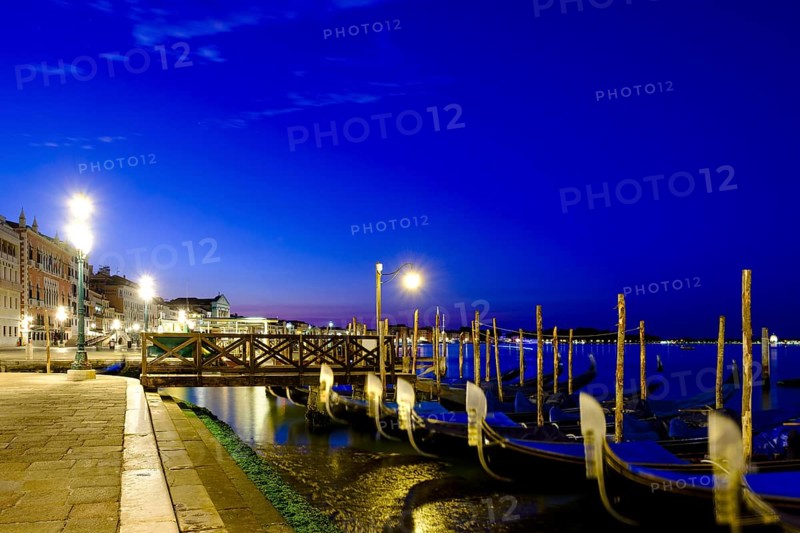 Gondolas at the quay of Riva degli Schiavoni at dusk