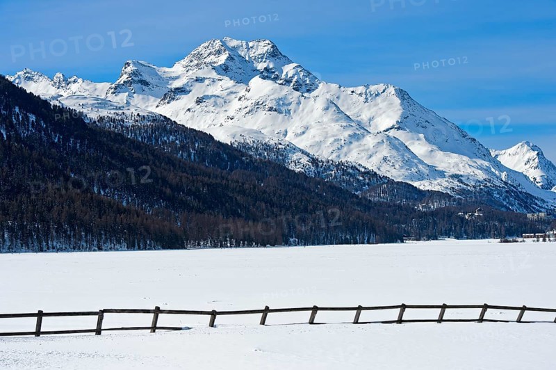 Summit Piz de la Margna above the frozen Lake Silvaplana