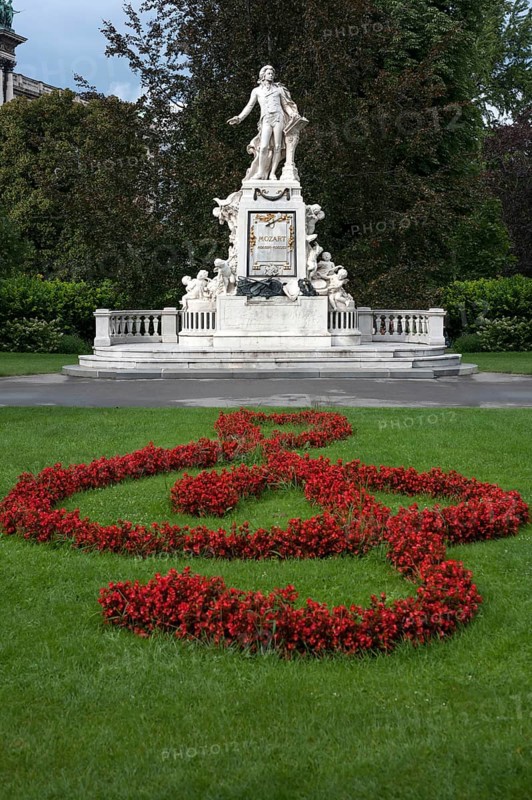 Red flowers arranged as violin key with Mozart monument
