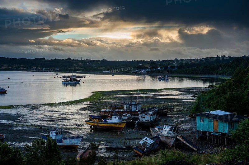Fishing boats at low tide and sunset in Dalcahue
