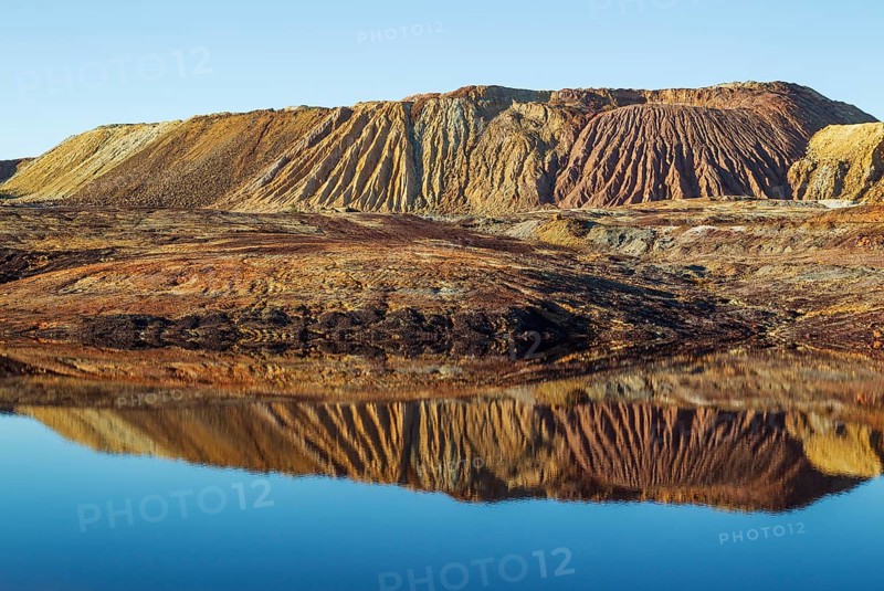 Mineral-rich ground and rocks with rainwater pool at Rio Tinto mines