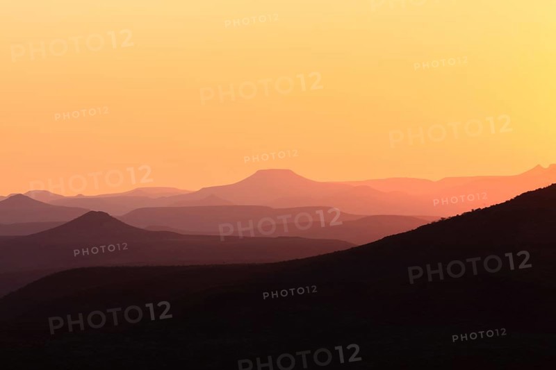 Staggered mountains at sunset